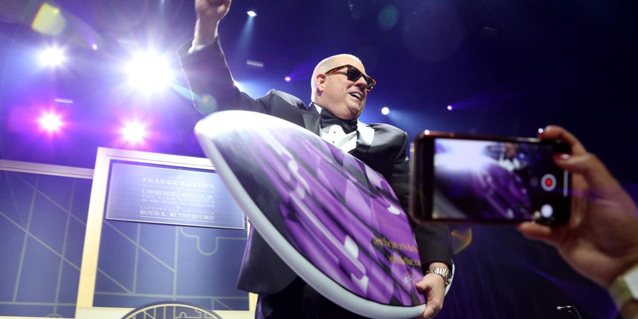 At his 2019 inaugural ball, Gov. Larry Hogan goofed around with a purple surfboard given to him by his State Police protection detail. In his new book, Hogan describes surfing the Democratic blue wave in the 2018 election that left other Republicans under water. Governor's Office photo